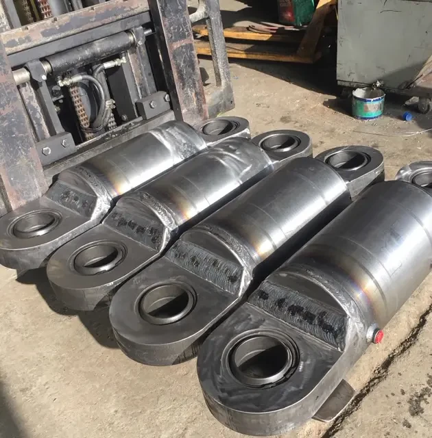 Hydraulic cylinder parts laid out for rebuild on workshop bench